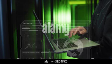 Typing mature Korean man using silver laptop in server room dark-jacket green HUD, copy space Stock Photo