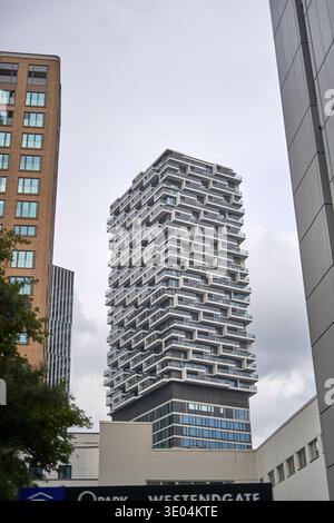 A modern residential building features a distinctive triangular roof ...