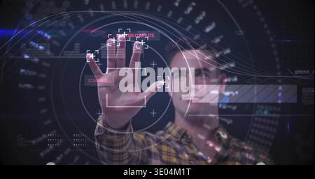 Reaching male operator using HUD in lab, with fingertip markers, wearing plaid shirt wristwatch Stock Photo
