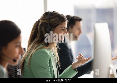 Hispanic female in headset live chat worker communicating on distance Stock Photo