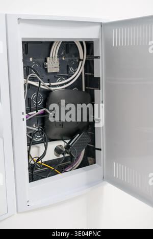 Open electrical distribution box with cables and network equipment Stock Photo