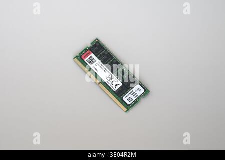 Close-up of a green DDR5 ECC RAM stick with labels and QR codes, isolated on plain white surface. Stock Photo