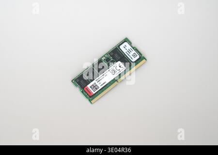 Close-up of a green DDR5 ECC RAM memory module with gold contacts and white label, isolated on white background. Stock Photo