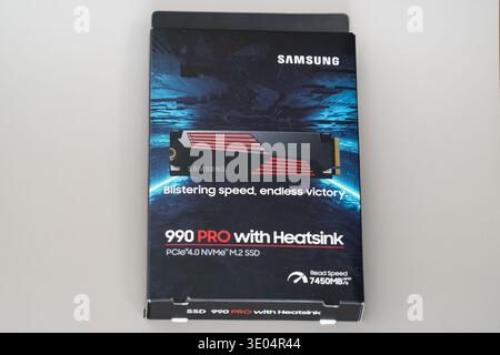 Box of Samsung 990 PRO NVMe M.2 SSD with heatsink, featuring up to 7450MB/s read speed and gaming-oriented design Stock Photo
