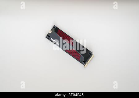 Close-up of a Samsung NVMe solid-state drive with red accents, isolated on white surface for tech product photography Stock Photo