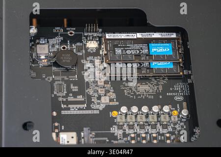 Close-up view of a mini PC's internal motherboard featuring two Crucial DDR5 SODIMM RAM sticks installed in memory slots. Stock Photo