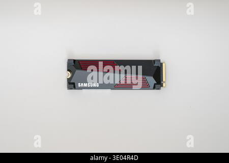 Black and red Samsung NVMe solid state drive isolated on white surface, high-angle shot Stock Photo