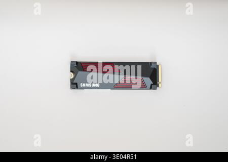 High-resolution studio shot of a Samsung NVMe solid-state drive with sleek black and red casing, isolated on white background. Stock Photo