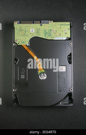 Close-up of a 24TB hard disk drive circuit board, showcasing internal components and connectivity for NAS systems amid memory and storage availability Stock Photo