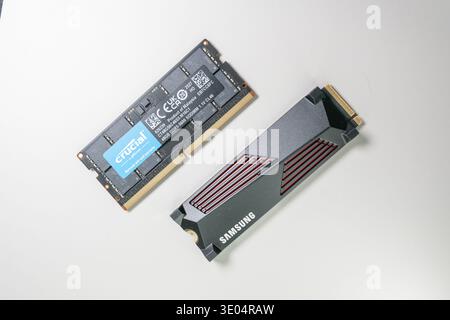 Close-up of Crucial DDR5 SODIMM memory module and Samsung NVMe solid-state drive, showcasing computer hardware components against a clean white surfac Stock Photo