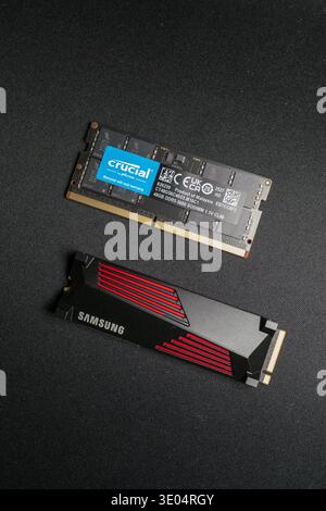 Two DDR5 memory sticks, one Crucial and one Samsung, displayed against a dark textured surface. Stock Photo
