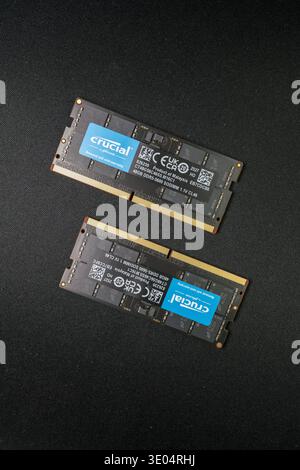 Two 48GB Crucial DDR5-5600 SODIMM memory modules displayed against a black textured surface, highlighting computer hardware and tech components. Stock Photo