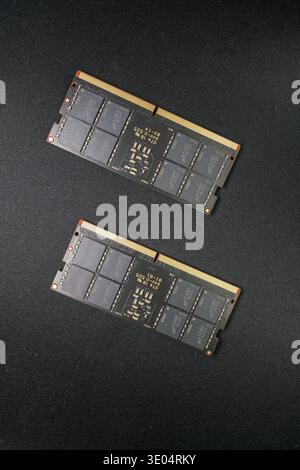 Two DDR5 RAM sticks displayed against dark fabric, highlighting semiconductor shortage and tech supply chain issues Stock Photo