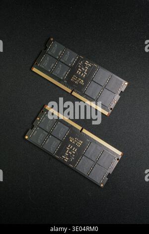 Two DDR5 RAM sticks displayed against dark fabric, highlighting semiconductor shortage and tech supply chain issues Stock Photo