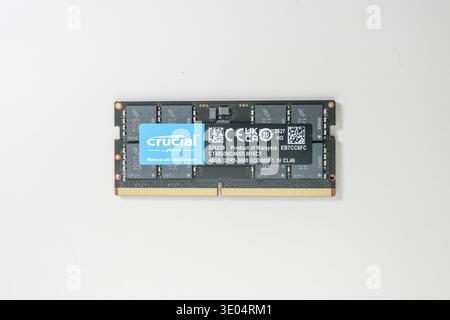 Close-up of a Crucial by Micron 48GB DDR5-5600 SODIMM memory module, labeled as product of Malaysia, isolated on white background. Stock Photo