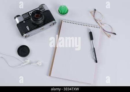 vintage camera and notebook lie on the table Stock Photo