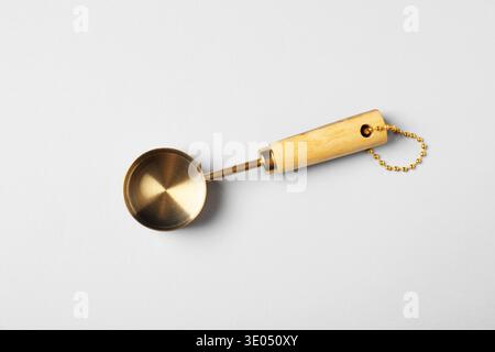Golden scoop on light background, top view Stock Photo