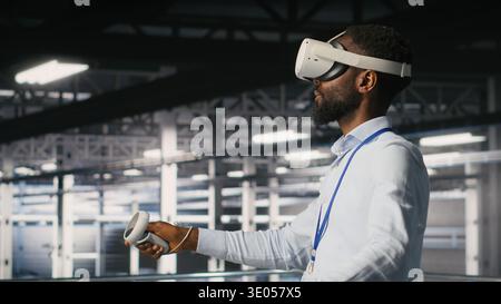 Data center programmers on industrial platform using virtual reality tech, collaborating on tasks. Server room IT professionals visualizing large language model architecture using VR headset Stock Photo