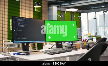 Isolated screen computer monitor in modern startup office displaying code snippets in various programming languages used for application development. Mockup PC in empty software agency workspace Stock Photo