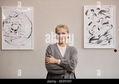 Portrait of Senior Caucasian Woman Standing Confidently in Art Gallery Stock Photo