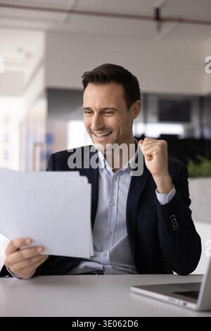 Hispanic corporate executive checking business papers at office workplace Stock Photo