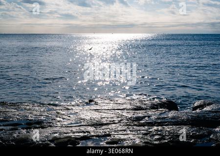 Coastal Rock Formation at Inamuragasaki with Sunlight Reflecting on Sea Surface Stock Photo