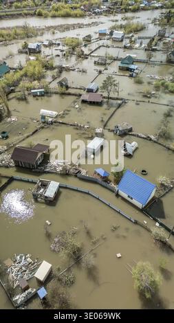 Spring flood disaster with fully submerged houses, flooded roads and ...