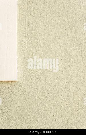Beige stucco wall texture with white window frame minimal architectural background Stock Photo