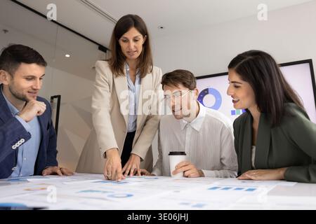 Team engaged in discussion, analyzing results and developing strategic ideas Stock Photo