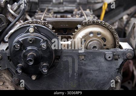 Gear chain drive shaft in conveyor belt is on production line. Timing chain of car, tensioners in engine. Industrial roller chain, technology. Team wo Stock Photo