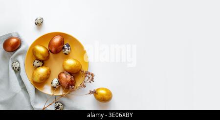 Golden and bronze Easter eggs in a orange plate Stock Photo