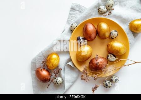 Golden and bronze Easter eggs in a orange plate Stock Photo
