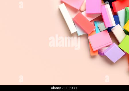 Many colorful rubber erasers on beige background Stock Photo