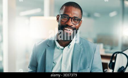 Portrait, call center and black man in office, glasses and success for tech support. African person, consultant and professional in workplace Stock Photo
