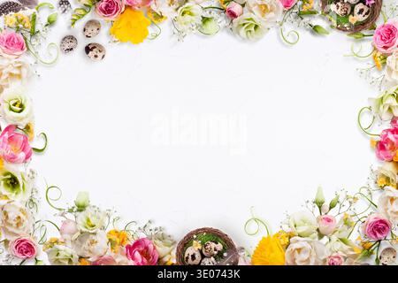 A white background with a flowery border and a basket of eggs in the middle Stock Photo