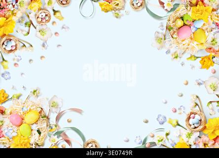 Colorful Easter-themed arrangement featuring decorated eggs, flowers, and nests on a light blue background, ideal for spring celebrations and holiday Stock Photo