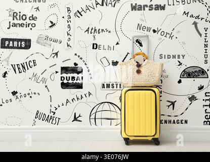 Suitcase with bag against drawing of cities to visit and symbols for travel methods on white wall. Journey planning Stock Photo