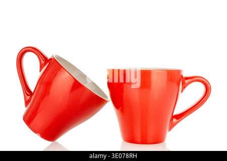 Two ceramic red coffee cups, close-up, isolated on white background. Stock Photo