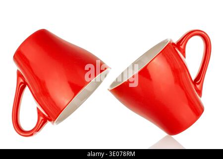 Two ceramic red coffee cups, close-up, isolated on white background. Stock Photo