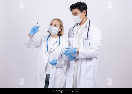 Male and female doctors discussing medical records Stock Photo
