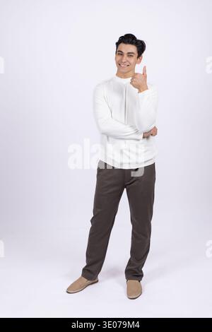 Thoughtful man in white sweatshirt touching his chin Stock Photo