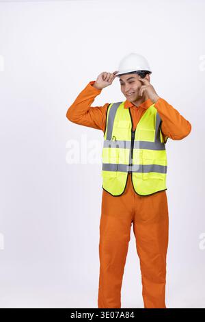 Construction worker in orange uniform and safety helmet Stock Photo