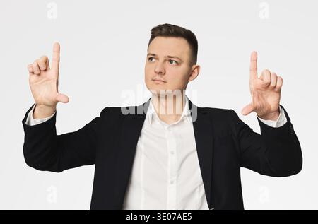 Young businessman using virtual screen for work Stock Photo