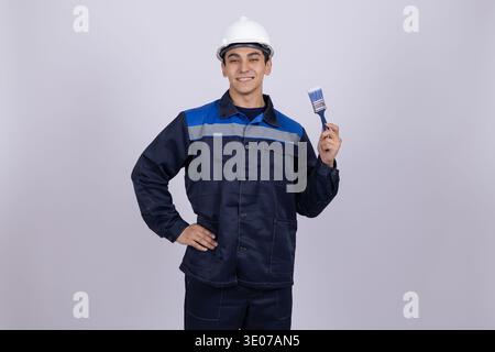 Construction worker holding a small tool Stock Photo