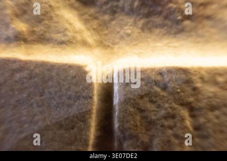 Light shining through stone wall cracks Stock Photo