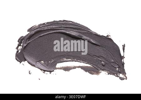 Black clay facial mask smear on white isolated background Stock Photo