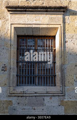 Detailed Facade Old Window with Iron Bars on Stone Building Stock Photo