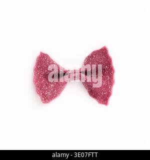 One purple farfalle pasta isolated on white Stock Photo
