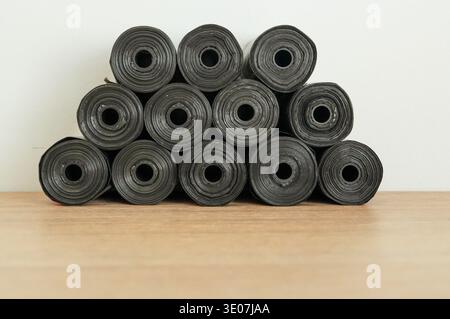 Construction garbage bags on a wooden table with a white background. Stock Photo