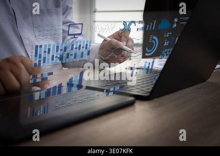 Business analytics dashboard on laptop with stylus, data analysis charts for performance report and KPI monitoring Stock Photo